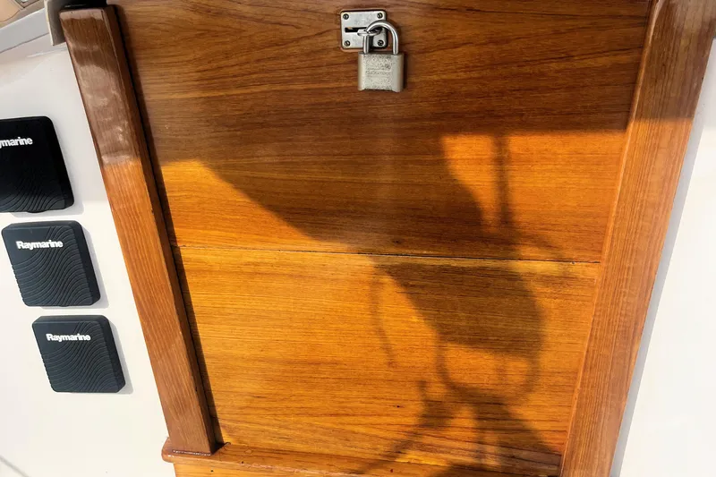 Slide: The Image of Wooden panel with padlock on a 1981 Bristol 40, featuring Raymarine equipment. - 3