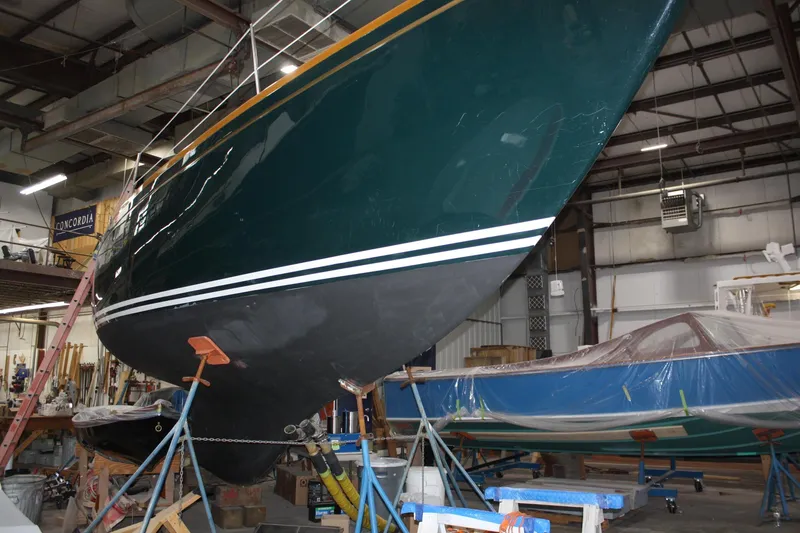 Slide: The Image of Interior of a 1981 Bristol 40 sailboat with wood paneling and green seating. - 36