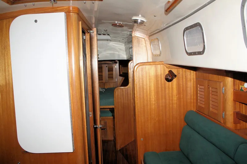 Slide: The Image of Interior of 1981 Bristol 40 sailboat with wooden paneling and green seating. - 41
