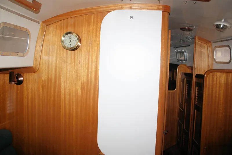 Slide: The Image of Interior of a 1981 Bristol 40 sailboat with wooden paneling and nautical clock. - 42
