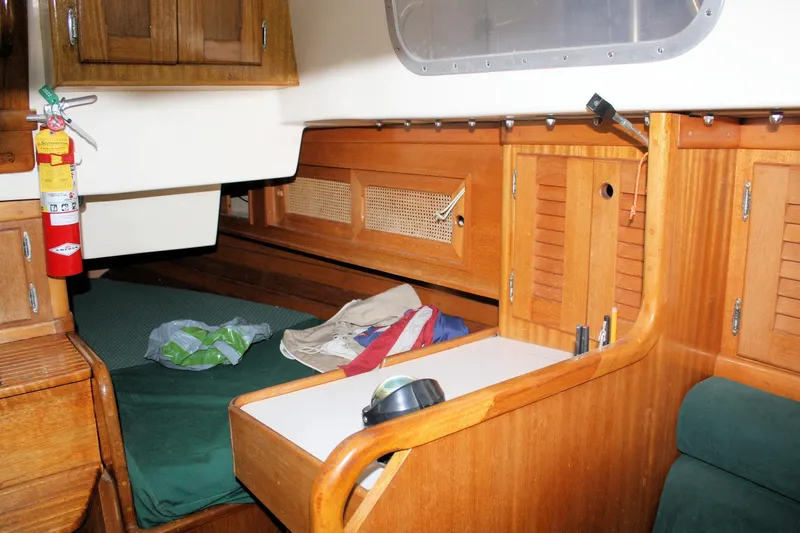 Slide: The Image of Interior of a 1981 Bristol 40 sailboat with wooden cabinetry and sleeping area. - 45