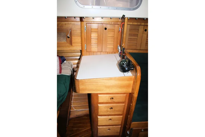 Slide: The Image of Interior of 1981 Bristol 40 sailboat with wooden cabinetry and navigation equipment. - 46
