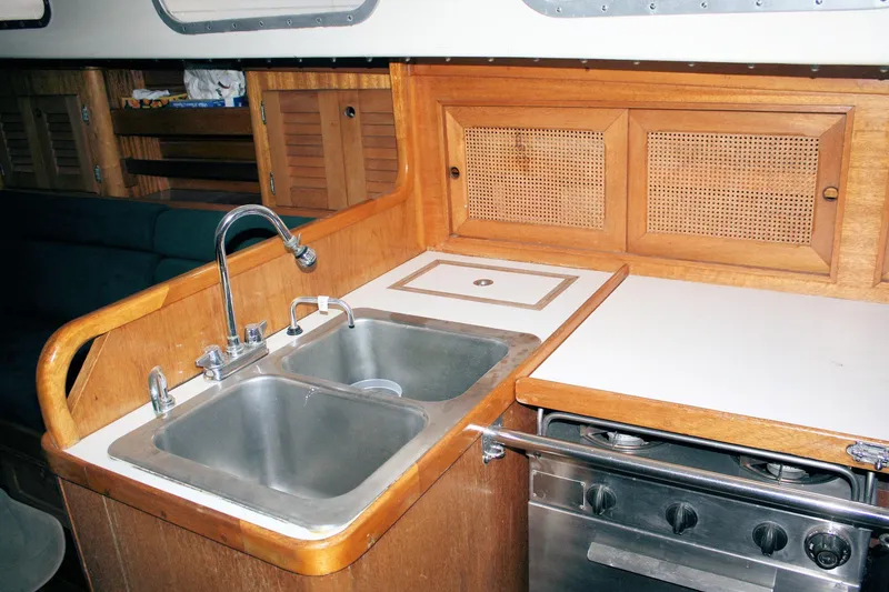 Slide: The Image of 1981 Bristol 40 yacht kitchen with stainless steel sink and wooden cabinetry. - 49