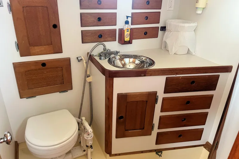 Slide: The Image of 1981 Bristol 40 yacht bathroom with wooden cabinets and compact sink. - 5