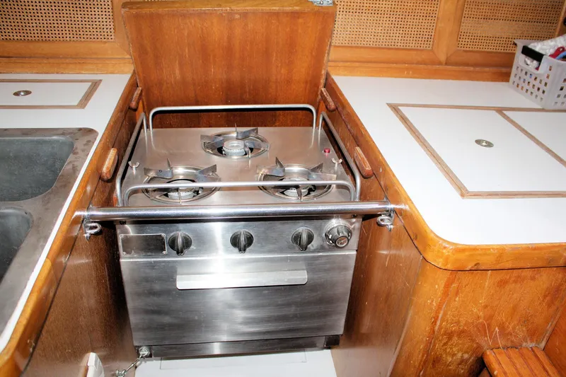 Slide: The Image of 1981 Bristol 40 yacht kitchen with stainless steel stove and wooden cabinetry. - 50
