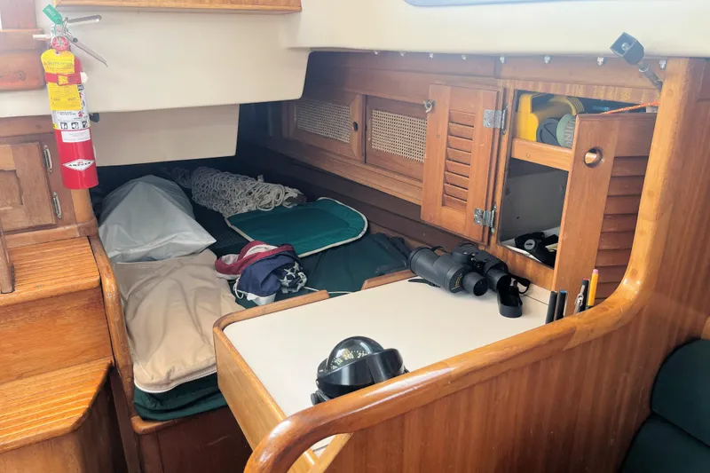 Slide: The Image of Interior of a 1981 Bristol 40 sailboat with wooden cabinetry and nautical equipment. - 7