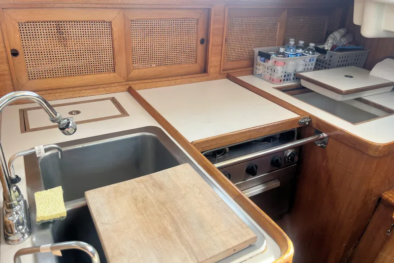 Slide: The Image of 1981 Bristol 40 yacht kitchen with sink, stove, and wooden cabinetry. - 9