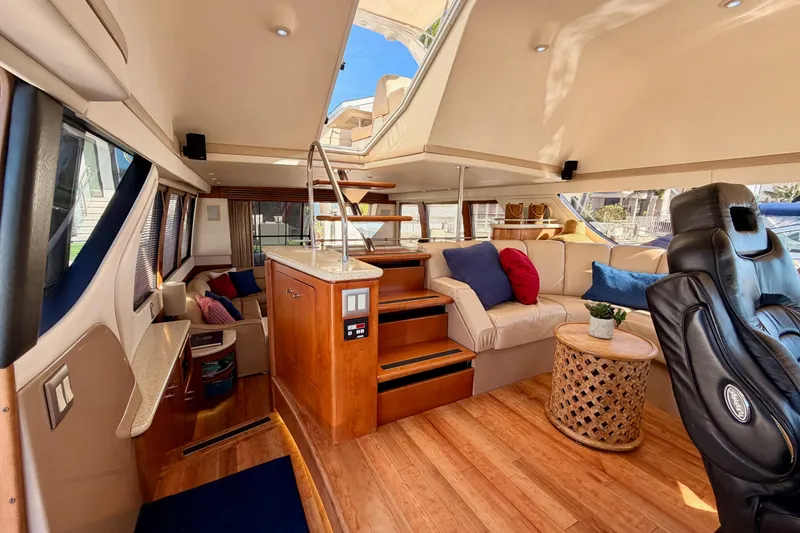 Slide: The Image of Luxurious interior of 1999 Carver 530 Voyager Pilothouse with plush seating and elegant wood finishes. - 105