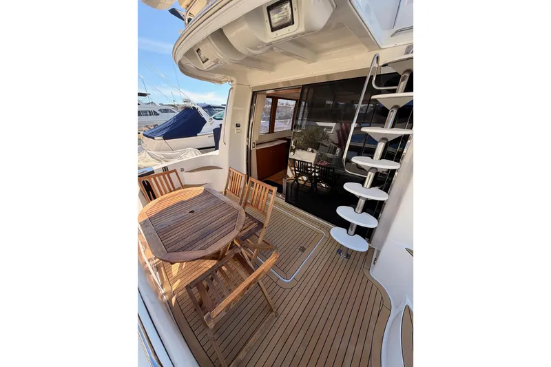 Slide: The Image of 1999 Carver 530 Voyager Pilothouse yacht with outdoor seating and spiral staircase. - 11