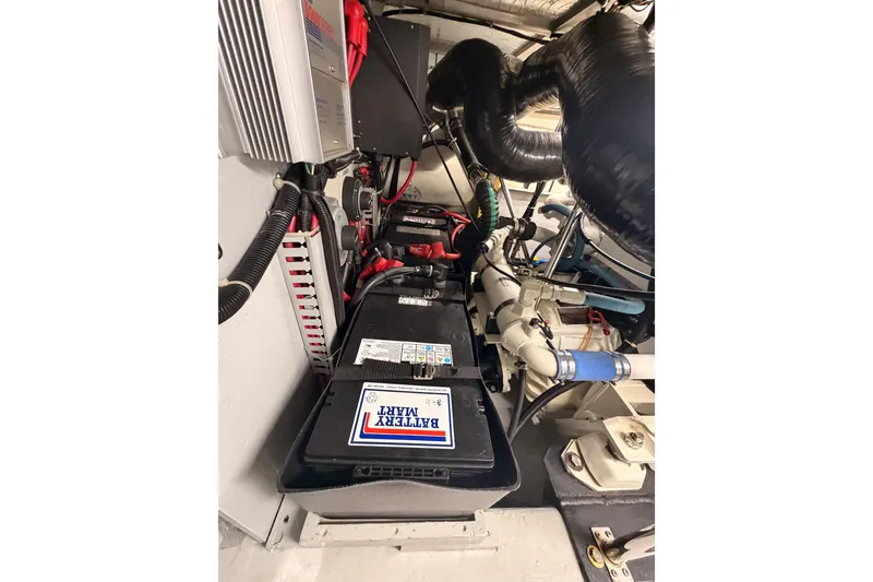 Slide: The Image of Engine room of 1999 Carver 530 Voyager Pilothouse with battery and wiring. - 111