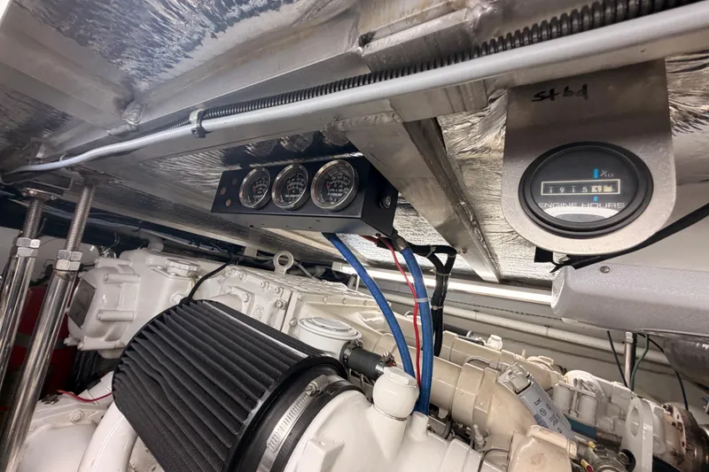 Slide: The Image of Engine room of 1999 Carver 530 Voyager Pilothouse with gauges and engine hour meter. - 115