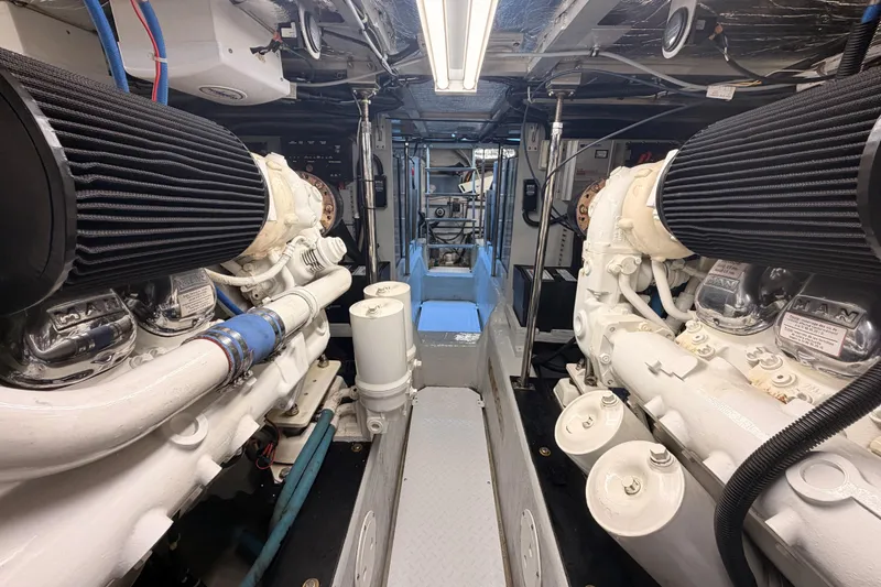 Slide: The Image of Engine room of 1999 Carver 530 Voyager Pilothouse with dual engines and mechanical components. - 123