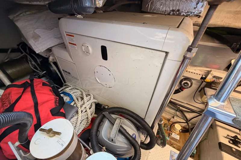 Slide: The Image of Engine room of 1999 Carver 530 Voyager Pilothouse with Kohler generator and equipment. - 131