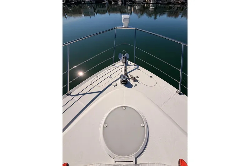 Slide: The Image of Bow view of 1999 Carver 530 Voyager Pilothouse yacht on calm water. - 15