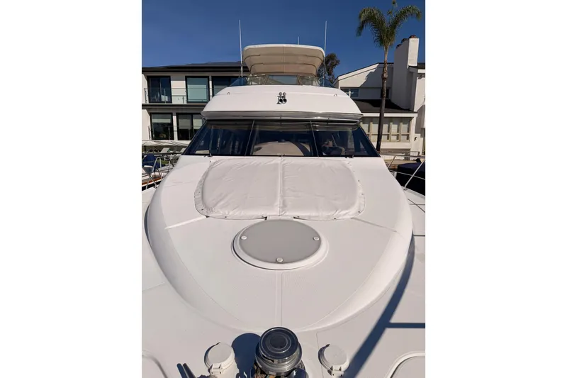 Slide: The Image of 1999 Carver 530 Voyager Pilothouse yacht docked, showcasing sleek design and spacious deck. - 20