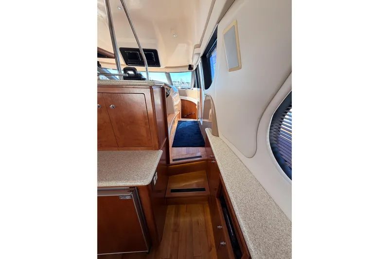 Slide: The Image of Interior of 1999 Carver 530 Voyager Pilothouse with wood cabinetry and blue carpet. - 38
