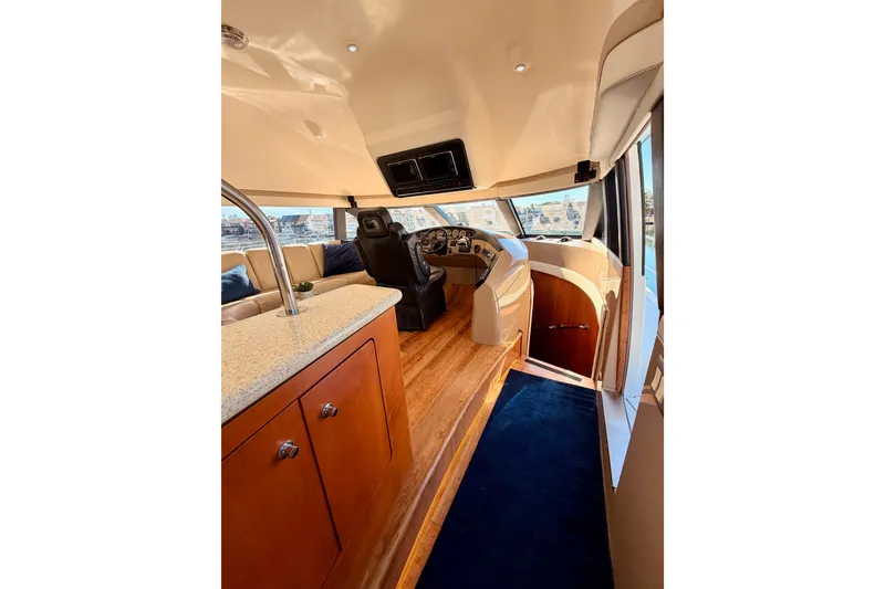 Slide: The Image of 1999 Carver 530 Voyager Pilothouse interior with helm, seating, and wood flooring. - 39