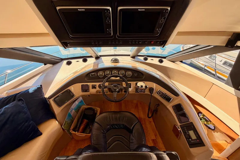 Slide: The Image of 1999 Carver 530 Voyager Pilothouse helm with modern navigation equipment and luxurious seating. - 41