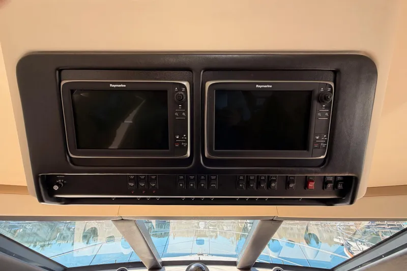 Slide: The Image of 1999 Carver 530 Voyager Pilothouse dashboard with Raymarine navigation displays. - 45