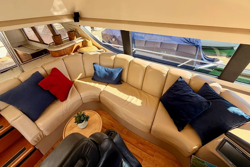 Slide: The Image of Luxurious interior of 1999 Carver 530 Voyager Pilothouse with plush seating and vibrant cushions. - 48