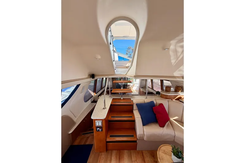 Slide: The Image of Interior of 1999 Carver 530 Voyager Pilothouse with elegant seating and natural light. - 49