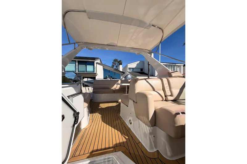 Slide: The Image of 1999 Carver 530 Voyager Pilothouse interior with beige seating and wooden flooring. - 50