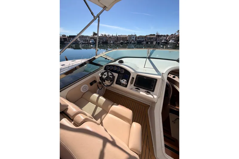 Slide: The Image of 1999 Carver 530 Voyager Pilothouse helm with leather seating and waterfront view. - 52