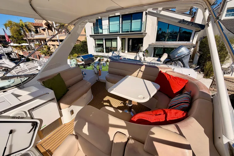 Slide: The Image of Luxurious 1999 Carver 530 Voyager Pilothouse yacht interior with plush seating and vibrant cushions. - 57