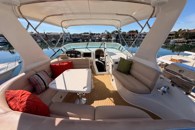 Slide: The Image of Luxurious 1999 Carver 530 Voyager Pilothouse yacht interior with plush seating and scenic marina view. - 67