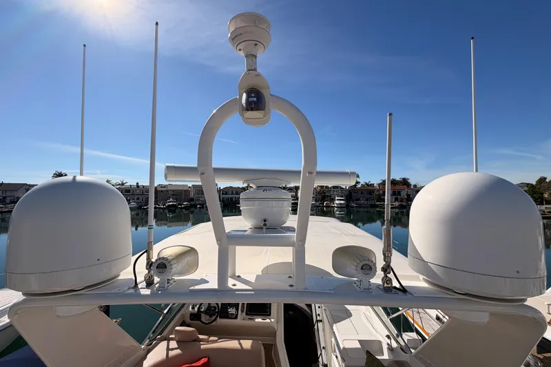 Slide: The Image of 1999 Carver 530 Voyager Pilothouse yacht with radar equipment under clear blue sky. - 68