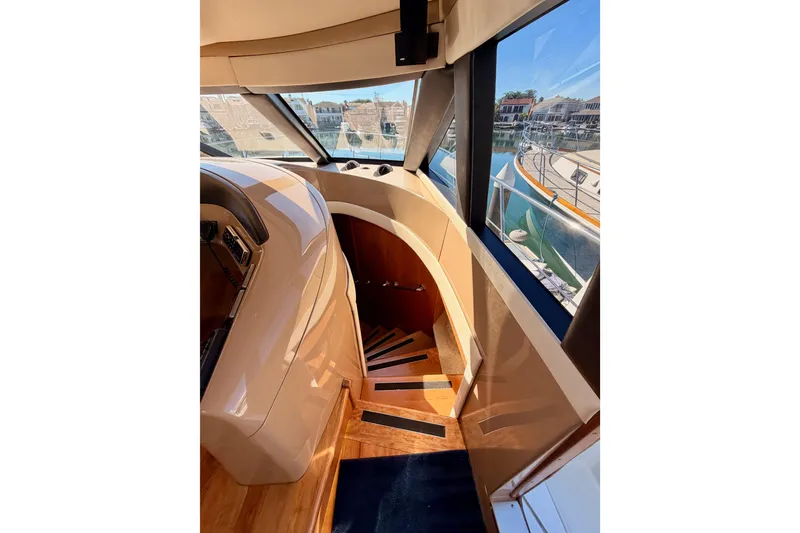 Slide: The Image of Interior view of 1999 Carver 530 Voyager Pilothouse with wooden stairs and large windows. - 71