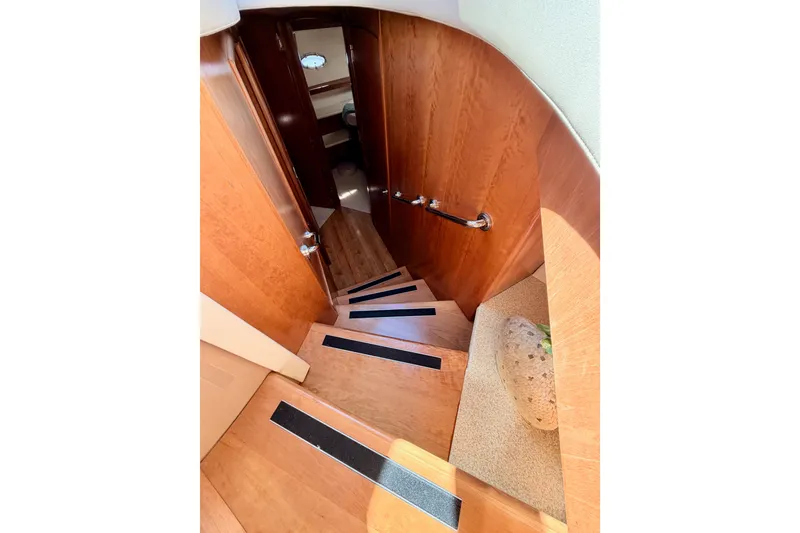 Slide: The Image of Staircase inside 1999 Carver 530 Voyager Pilothouse with wooden finish and handrail. - 72