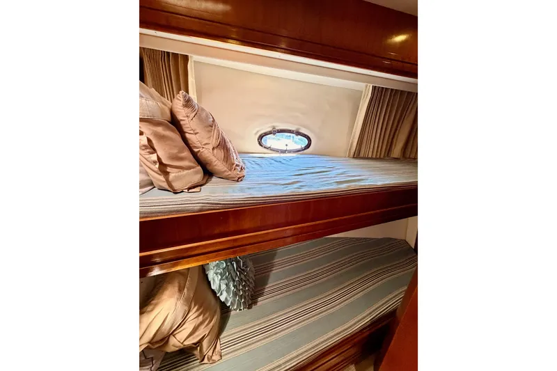 Slide: The Image of 1999 Carver 530 Voyager Pilothouse interior with cozy bunk beds and porthole window. - 76