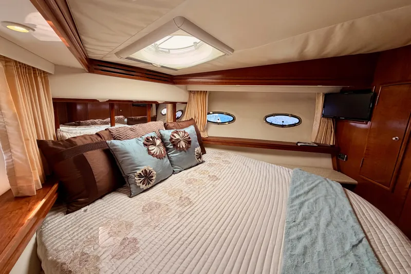 Slide: The Image of Luxurious bedroom interior of 1999 Carver 530 Voyager Pilothouse yacht with elegant decor. - 82