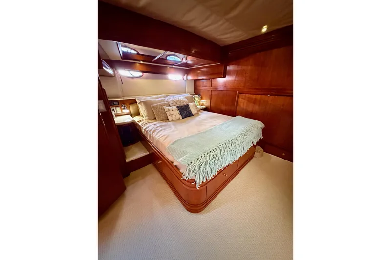 Slide: The Image of Luxurious bedroom interior of 1999 Carver 530 Voyager Pilothouse yacht with elegant wood finish. - 88