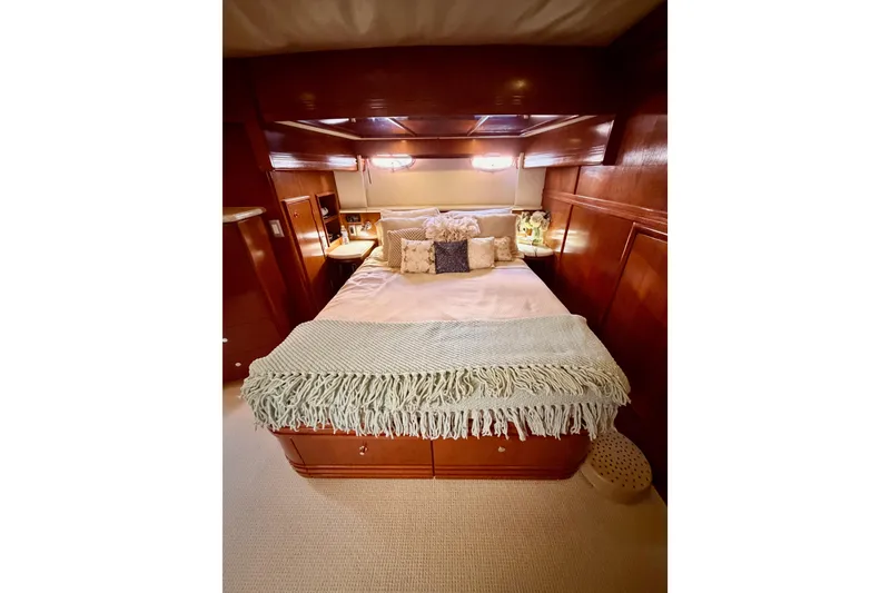 Slide: The Image of Luxurious bedroom interior of 1999 Carver 530 Voyager Pilothouse yacht with cozy bedding. - 89