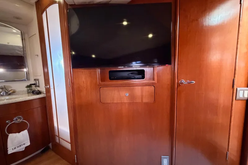 Slide: The Image of Interior of 1999 Carver 530 Voyager Pilothouse with TV and wooden cabinetry. - 100