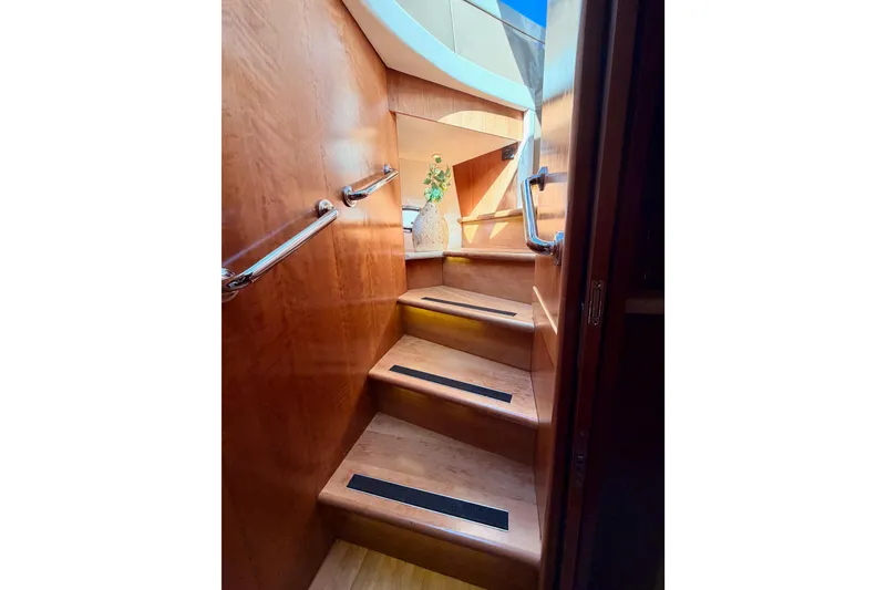 Slide: The Image of Staircase inside 1999 Carver 530 Voyager Pilothouse with wooden finish and handrails. - 103