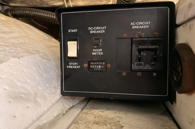 Slide: The Image of Control panel of a 1999 Carver 530 Voyager Pilothouse with circuit breakers and hour meter. - 107
