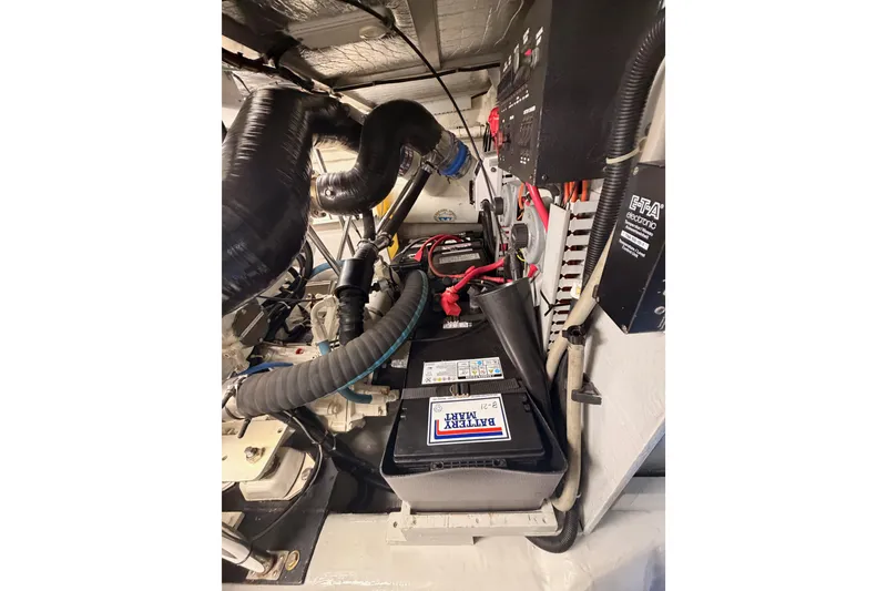Slide: The Image of Engine room of 1999 Carver 530 Voyager Pilothouse with battery and wiring. - 112
