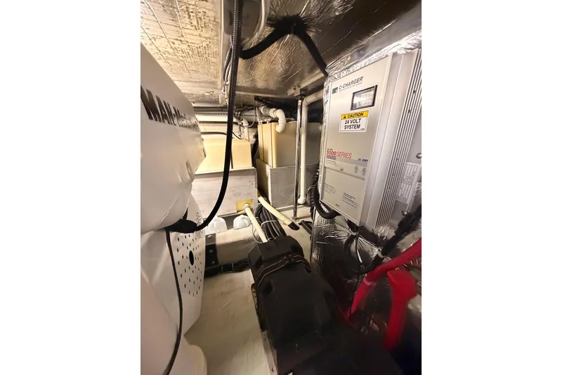 Slide: The Image of Engine room of 1999 Carver 530 Voyager Pilothouse with electrical systems and wiring. - 118