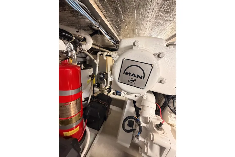 Slide: The Image of Engine room of 1999 Carver 530 Voyager Pilothouse with MAN engine and fire extinguisher. - 119