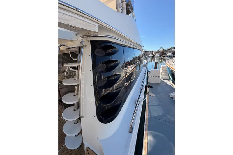 Slide: The Image of 1999 Carver 530 Voyager Pilothouse yacht with sleek design and reflective windows. - 12