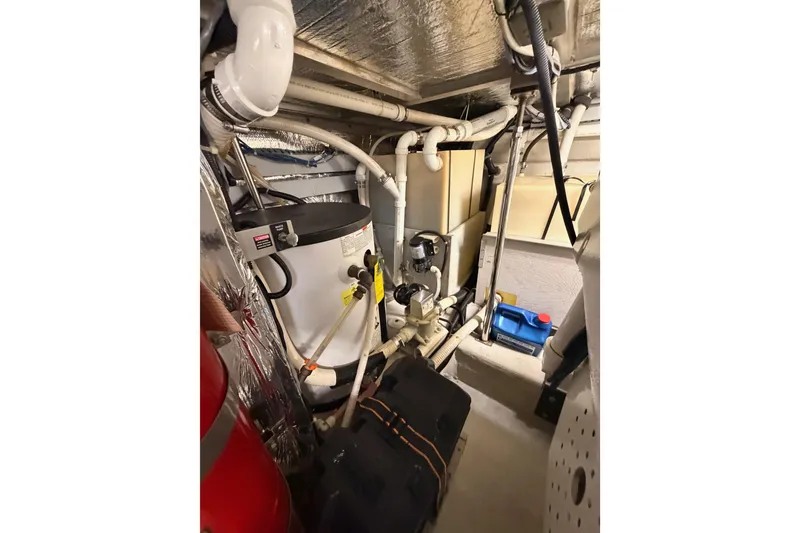 Slide: The Image of Engine room of 1999 Carver 530 Voyager Pilothouse with mechanical equipment and piping. - 120