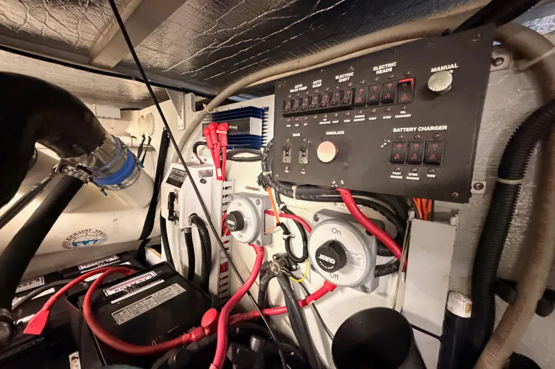 Slide: The Image of Engine room of 1999 Carver 530 Voyager Pilothouse with control panel and battery setup. - 126