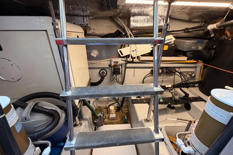 Slide: The Image of Engine room of 1999 Carver 530 Voyager Pilothouse with ladder and equipment. - 128