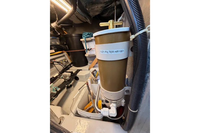Slide: The Image of Engine room of 1999 Carver 530 Voyager Pilothouse with filter and equipment. - 129