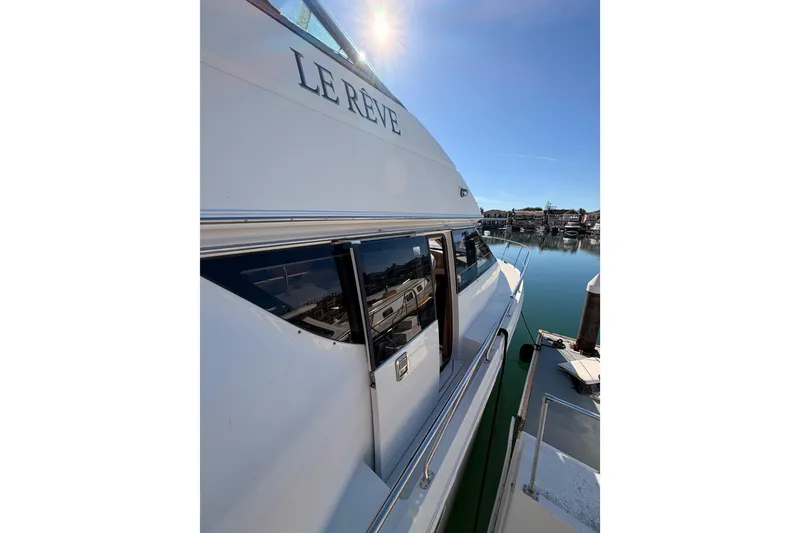 Slide: The Image of 1999 Carver 530 Voyager Pilothouse yacht docked in sunny marina. - 13