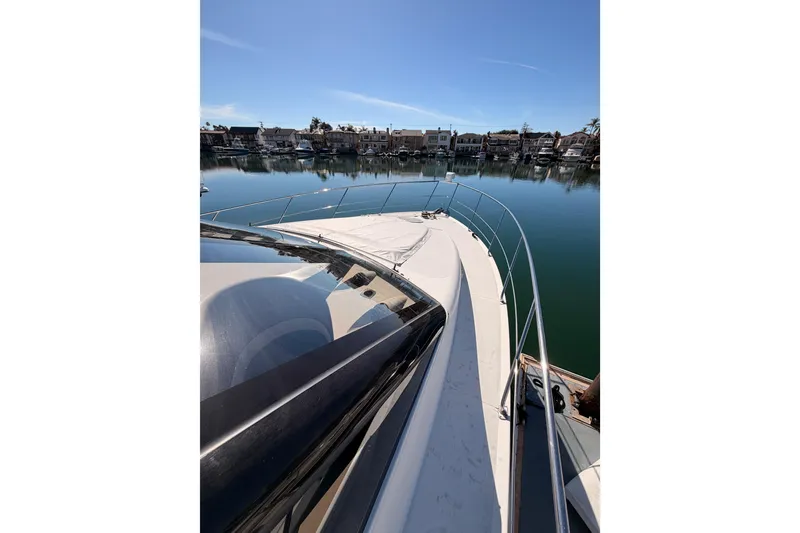 Slide: The Image of 1999 Carver 530 Voyager Pilothouse yacht docked in a serene marina setting. - 14
