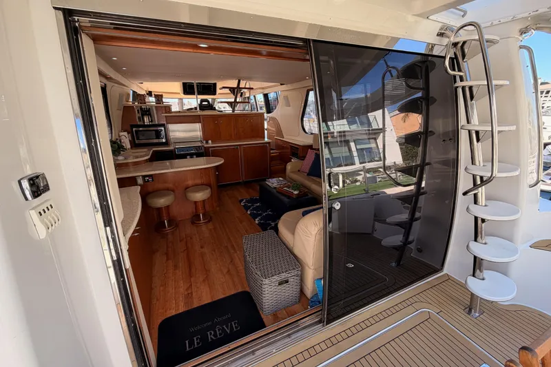 Slide: The Image of Interior view of 1999 Carver 530 Voyager Pilothouse yacht, featuring luxurious seating and modern amenities. - 23